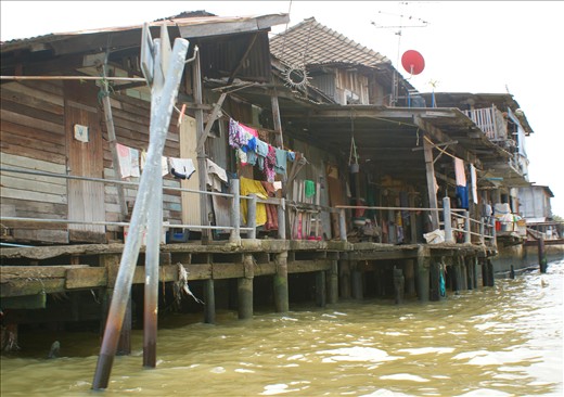 Bangkok, Thailand: rundown houses line the edges of the Chao Phraya river. 