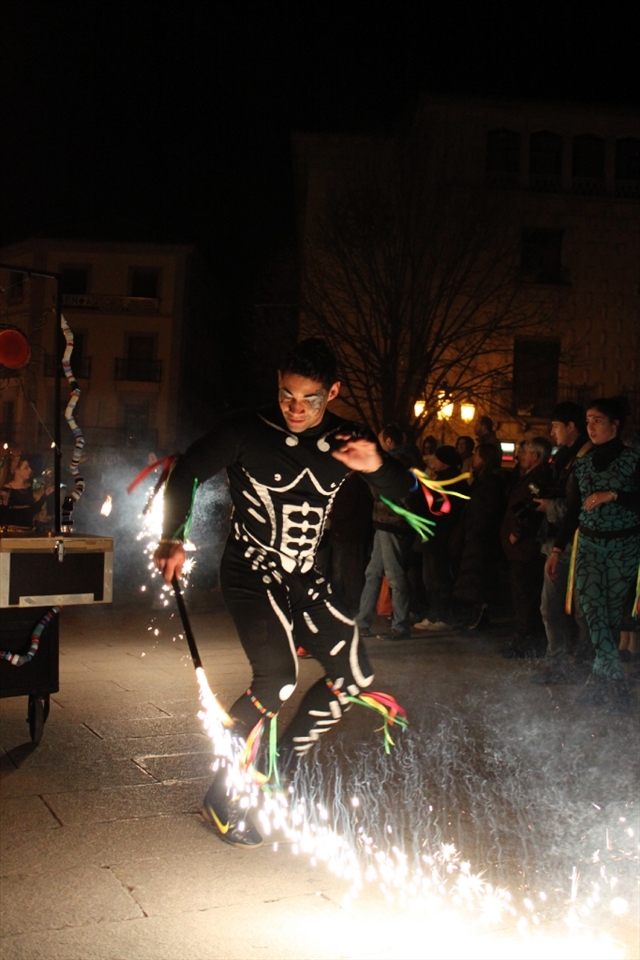 The acrobat's attire resembles a skeleton, harkening a literal interpretation of carnival or 