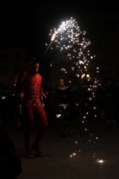 The acrobat and fire thrower alternate between waving batons of sparklers, clearing crowds, and swinging flaming balls of cloth attached to chains.: by lindsaypond, Views[544]