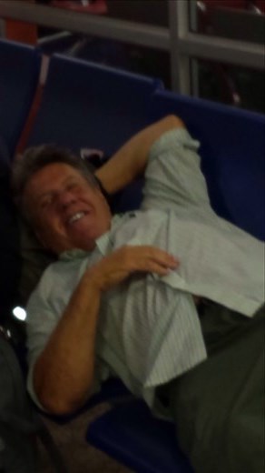 Fortunately an armrest was missing on one of the seats so I was able to lay down. A guy traveling to Zürich Switzerland was nice enough to take my picture.