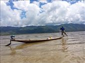 Great coordination. Net fisherman using both hands to pull in a net while paddling the boat with his foot and leg.: by lipowcan8, Views[345]