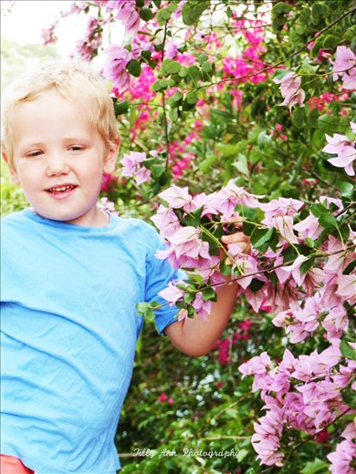 This photo is beautiful as it symbols a child's ease at finding joy in  the things adults easily overlook. It is a sign of the joy to be found in the simple things right outside our front door.