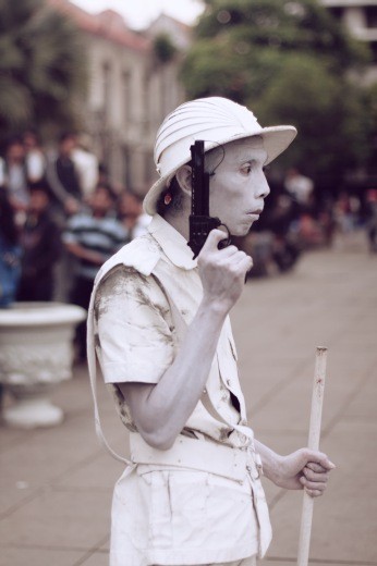 An all in white pantomime guy with sad eyes.