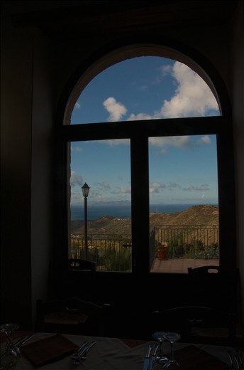 La Cucina: The second thing of I think of, when I remember Sicily. Food glorious food, wonderful food. Oh the food, so simple, yet so delicious and so fresh. This photo was taken at Mortizzi, another small village, up another extremely windy goat track, on the side of a hill. This is the village where my Dad was born and before my dad left Italy, the village consisted of two houses (a white house and a pink house). Since then, the owners of the land (still the same family that owned the land when Dad lived there) have built a restaurant (Villa Rica) and converted the pink and white houses into a Bed & Breakfast. The restaurant was closed when we visited, but the owner (the son of the original owner) invited us in for some food, and a vino and a chat. The guy was probably at least 80 years old and remembers my Nonno and Dad. He told stories of how my family used to cultivate the land for his father- oranges, olives, stone fruit, wheat - and in return my family would get to live in the white house for free and keep half of the produce to sell. Nonno used to also manually press the olives with the olive press to make oil. The press is now a feature in the restuarant. This photo is taken from inside the restaurant overlooking the fertile volcanic soil, that is used to grow most of the produce that is used in Villa Rica, and other restaurants around town. In the foreground you can see a table set, ready for evening visitors to the restaurant. I love how the window frames the 'bella vista' of the fertile land and the Aeolian Islands in the distant background. 