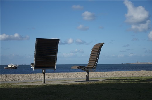 Lover's seats overlooking the blue bay on splendid day.