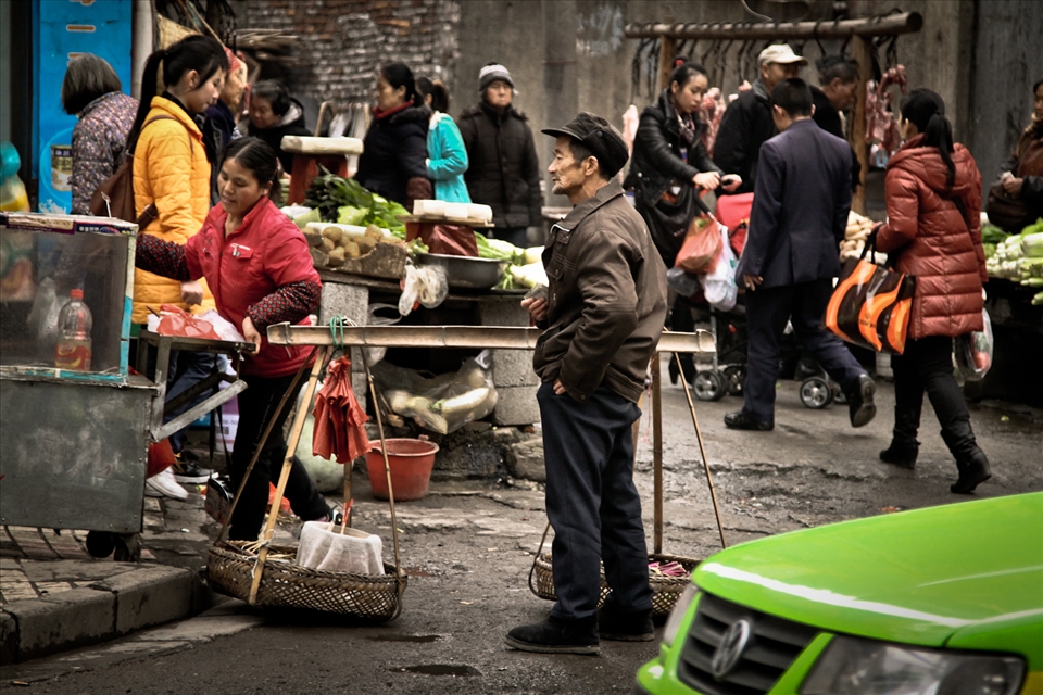 A street market in Hunan Province's Zhangjiajie. Everyday produce is brought into town and sold in makeshift markets scattered throughout Chinese cities. This basic form of commerce is still widespread in a country that also counts luxurious supermarkets and high-end car dealerships.