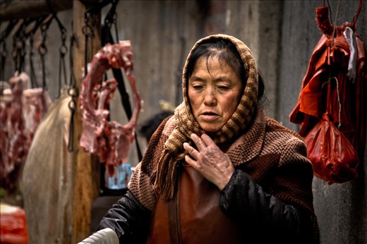 A butcher at a small improvised market in Hunan Province's Zhangjiajie, one of China's many cities with a population of over 1 million that is little-known outside of the country. 