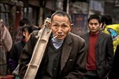 A laborer walks down a busy Zhangjiajie street with his biandan (two baskets and bamboo pole) slung casually over his shoulder and a cigarette dangling effortlessly from the corner of his mouth. : by littletrades, Views[820]