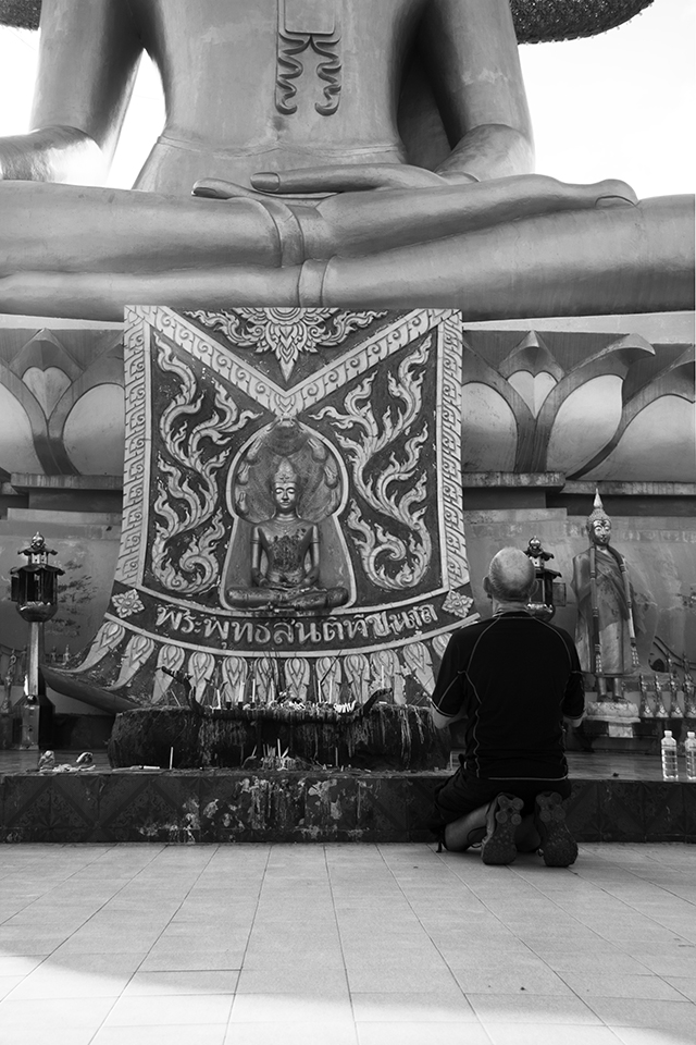 Praying in front of a giant Buddah.