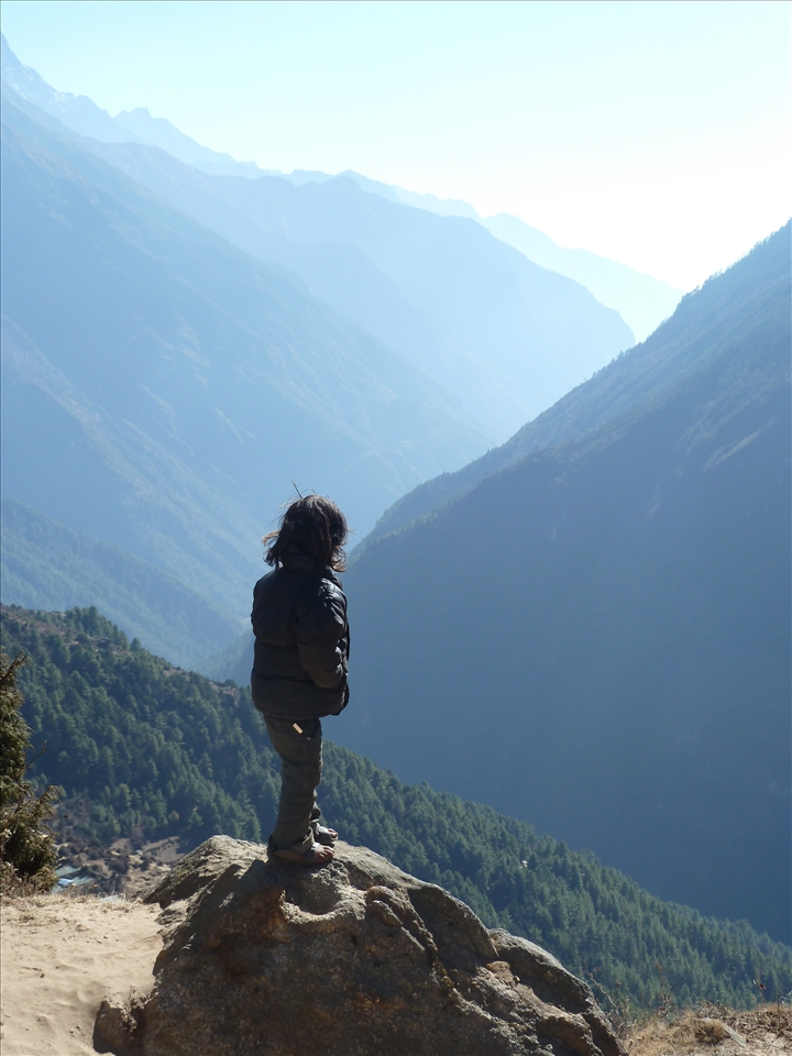 It's a big wide world out there- a small girl ponders what's out there as she looks across the Himalayas. Life growing up in this wonderful mountain range can be magical and challenging at the same time. This image tries to capture pondering in it's rawest form. 