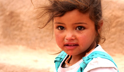 A young bedouin girl in Petra - her hair wild and her eyes teary due to the wind