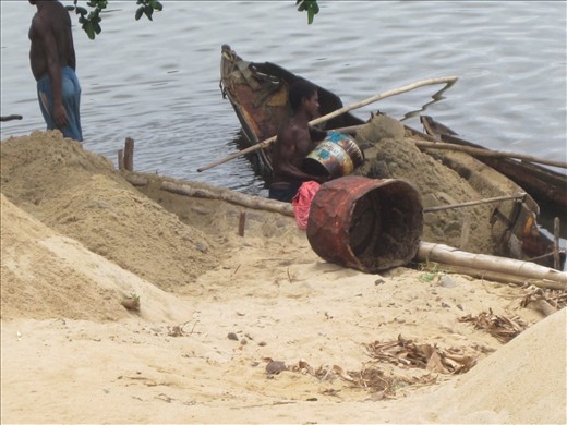 Man melding into boat... There is a black man, next to the boat, if you look.