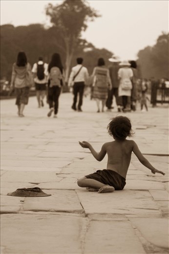 A despondent child begging for money in Siem Reap
