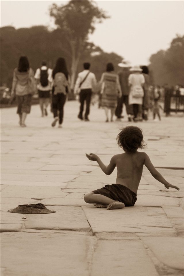 A despondent child begging for money in Siem Reap