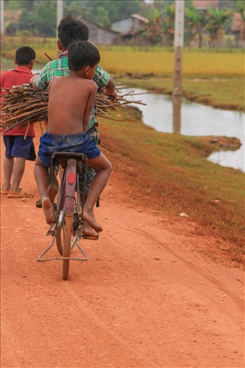 Children cycling home after collecting sticks throughout the day
