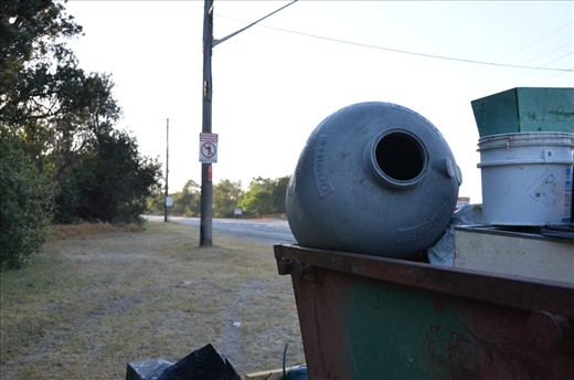 Before a warning to those who dump waste, is a skip full of dumped rubbish and chemical containers. But this was nothing compared to the small, illegal dumps just metres from road, obscured by the marsh.