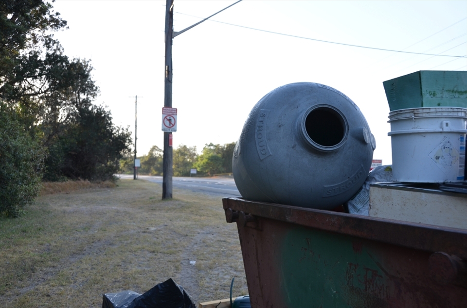 Before a warning to those who dump waste, is a skip full of dumped rubbish and chemical containers. But this was nothing compared to the small, illegal dumps just metres from road, obscured by the marsh.