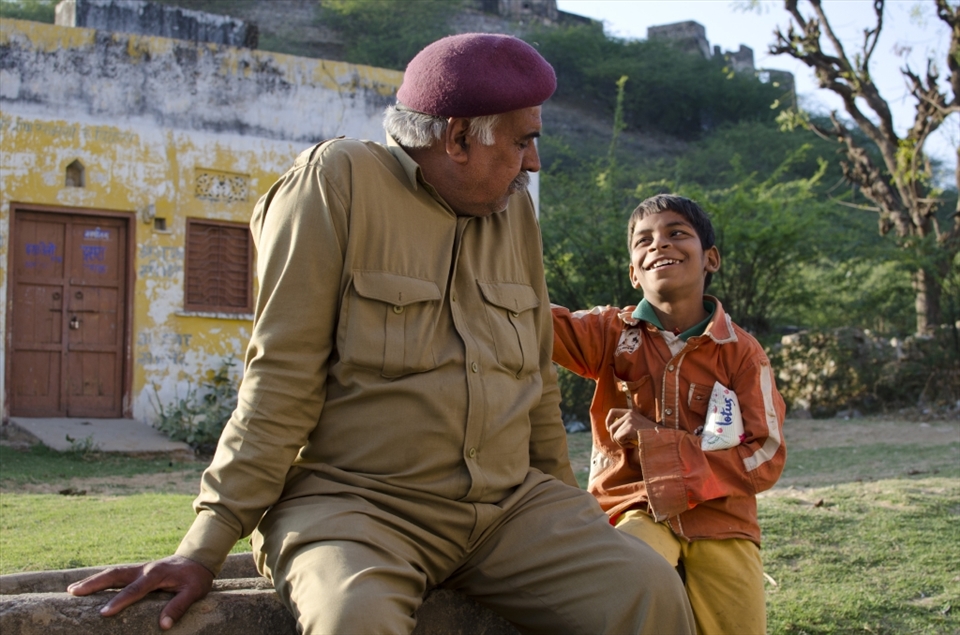A cheeky young boy, defending his lotus crisps enjoying the simple pleasure of life having a joke with the local village security. Looking after all the kids of the village while the parents are out picking cotton and opium, the man takes up the arduous challenge.