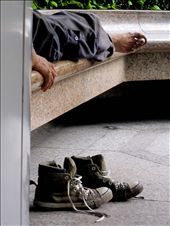 A homeless man rests his feet outside a subway station on Hong Kong Island.: by lor_lor201, Views[437]