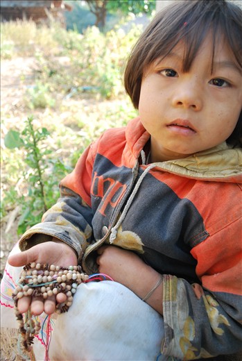 Children are taught young how to make jewelry out of beans to sell to tourists. 