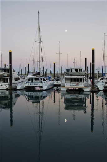 Full moon rising over the marina and people settle in for the night.