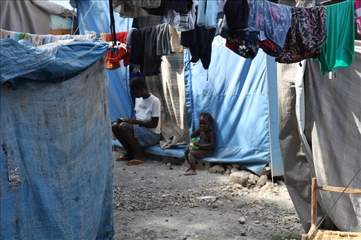 Amidst the chaos of a Tent City after the earthquake, a young girl gets on with her school work while her younger sister watches on. The Haitian peoples resilience and desire to gain a better life, never failed to amaze me.