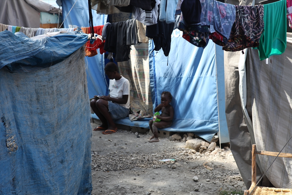 Amidst the chaos of a Tent City after the earthquake, a young girl gets on with her school work while her younger sister watches on. The Haitian peoples resilience and desire to gain a better life, never failed to amaze me.