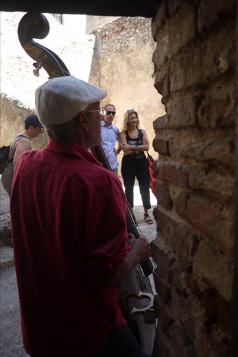 a musician plays for tourists at the Castillo de San Pedro de la Roca