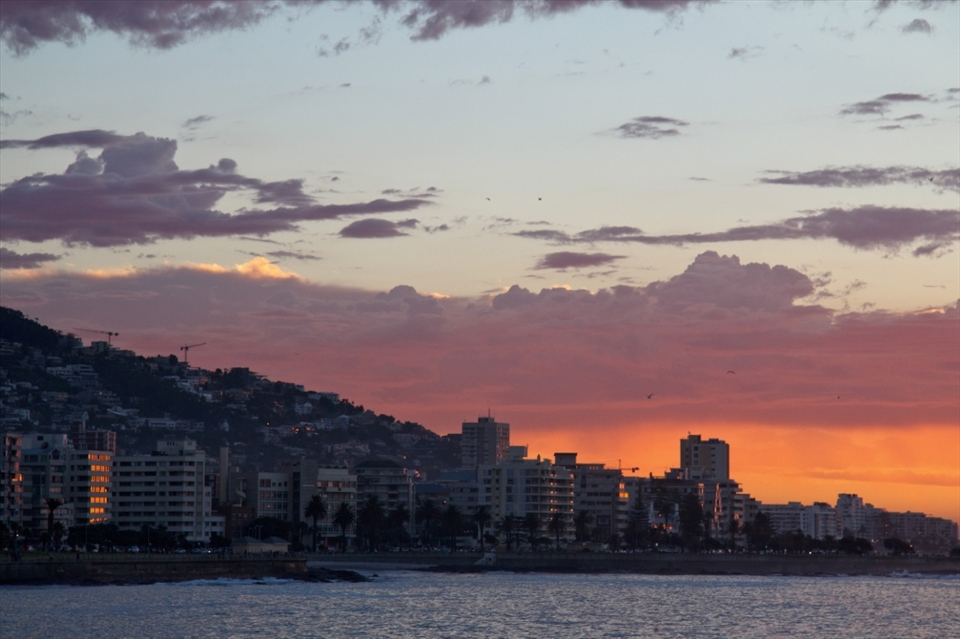 The promenade in Sea Point is one of my favorite places to walk alone. People of all kinds jog, exercise, walk their dogs or idle their cars in parking lots next to the ocean to watch the sunset.

Right now, the platform from which this photo was taken is being excavated to rebuild the sea wall - construction crews uncovered hundreds of old glass bottles and ceramics from what used to be an old rubbish tip.