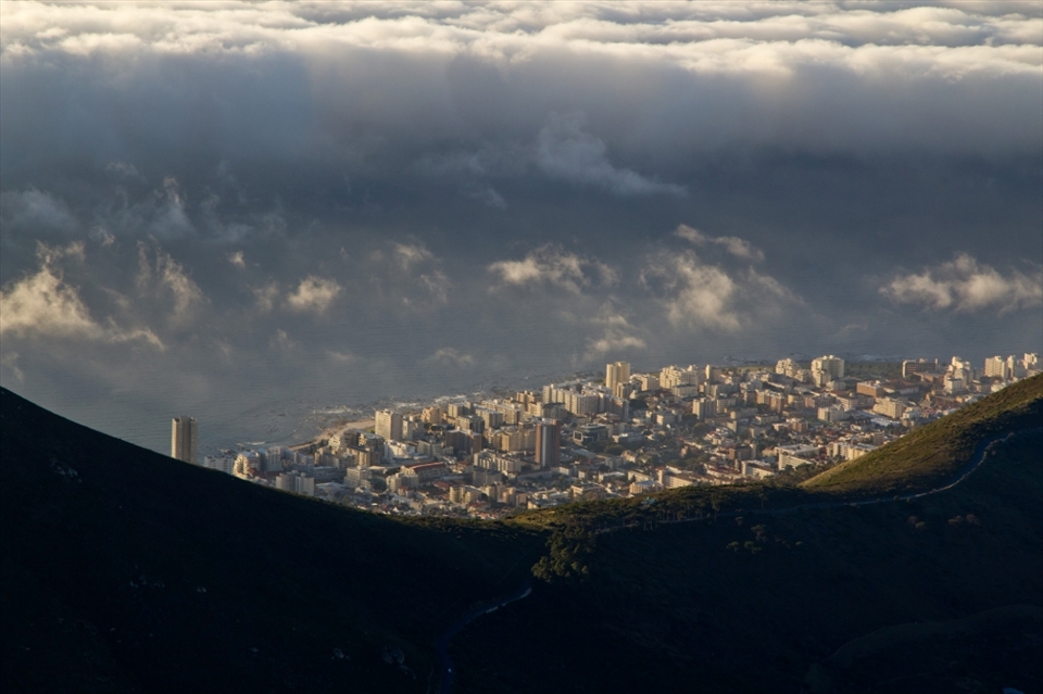 A view of Sea Point peeks out from between the saddle of Lion's Head and Signal Hill, nestled between shore and mountain.

Table Mountain is a sacred place, mythically, to the nomadic hunter gatherers that lived in this region. Known as the 