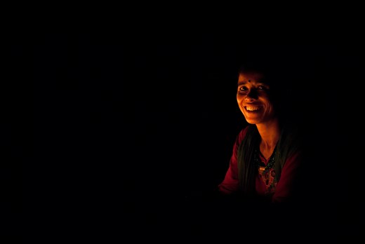 Imobilized woman by the candles. Swayambhunath Temple, Kathmandu.