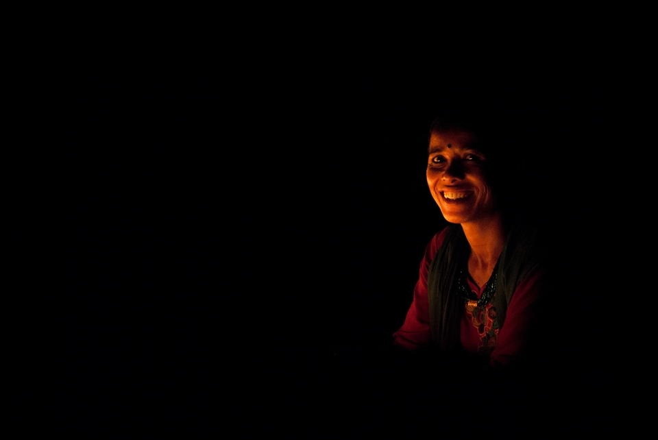Imobilized woman by the candles. Swayambhunath Temple, Kathmandu.