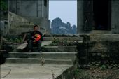 A man and son sit outside their home in Kenh Ga. Kenh Ga, and much of the surrounding area, is enveloped by large karst topographies.: by lucyellensteadman, Views[318]