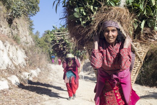 Women with traditional baskets full of foliage