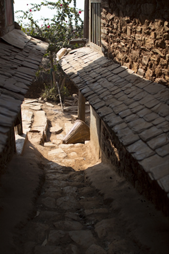 Traditional conical basket in courtyard in sunlight