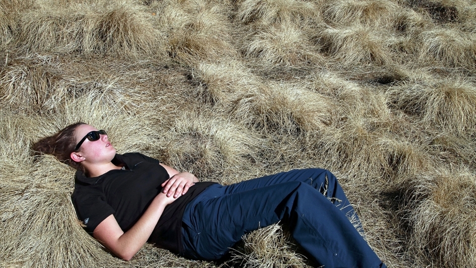 Emily gets lost in the grass. Altitude sickness can be deadly if you continue to climb once you feel the symptoms, so we made lots of rest stops once we reached the 4000m mark.  
