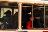 The only girl on this crowded bus is dressed all in red. She has a mysterious look and she stares at me - with the subtle detail of one eye covered by the frame of the window - Meanwhile, this busy bus goes wobbling around down Cusco's mazy streets, and we are never gonna se each other again.: by luigiluigi, Views[944]