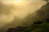 'Gold in them hills'.
Chapter 2.
An intense thunderstorm woke me up in the middle of the night. But I was supposed to leave by night, and I left. You cannot wake up at 9 if you want to see the sunrise at Machu Picchu.
It seemed as if the rain were improvising a symphony. Every drop of water did different sounds while reaching the leaves of any kind of tropical plants. After walking through the gloomy jungle I arrived to the entrance of Machu Picchu. 
Our Sun unveils the characteristic lines of Machu Picchu against the dense, shallow clouds and the bright mist that cover the Lost City of the Incas: by luigimeetsworld, Views[1193]