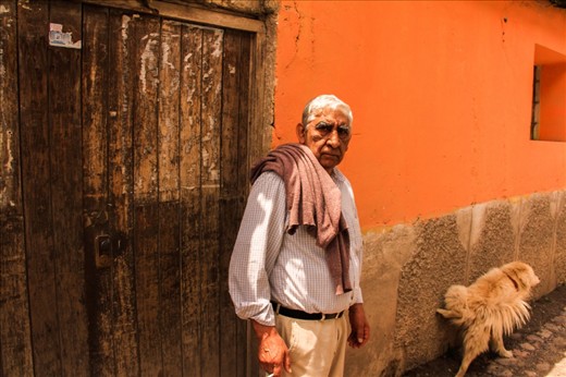 'Contact'.
Chapter 3. I move on. The road keeps doing zig zag. After passing 2 or 3 small villages hidden either by clouds or mountains, I stop. I take some time to study the inhabitants. This is no longer Machu Picchu and they're not that used to interact with strangers. This man turns back the exact moment I press the shutter -  while his dog, well, was at the toilette.
