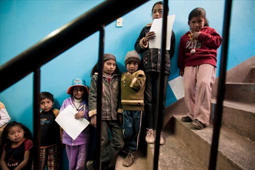 Children waiting for free medical examinations provided by Maximo Nivel Intercultural Centre medical volunteers in Cusco, Peru.  These services are often the only checkup these children have growing up.