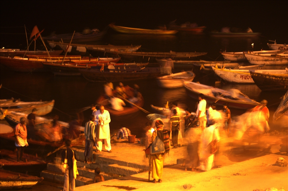 As night falls over a holy river, an old man waits