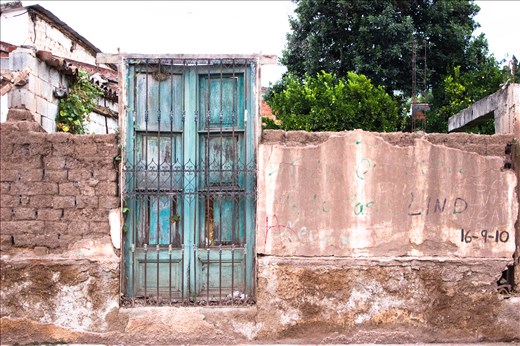 not just a striking blue door, but  a demolished house where a family from Salta lived 