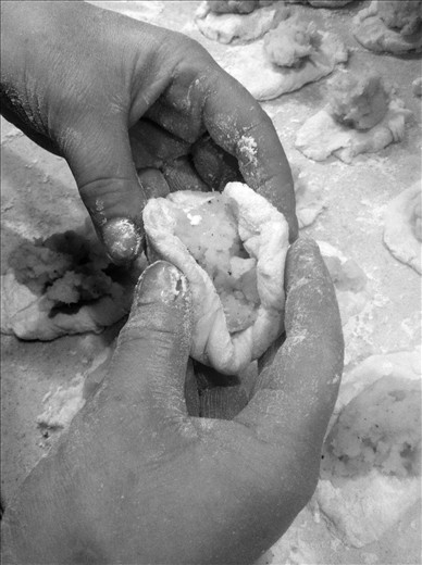 Carefully pinching the sides together 