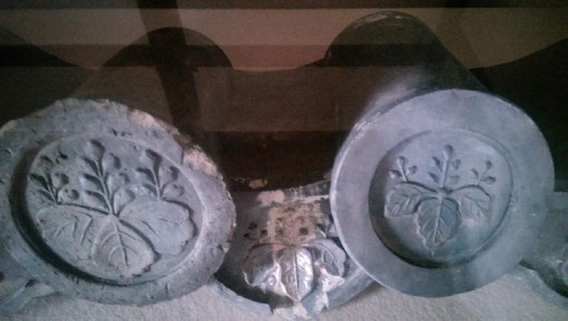 These are Tekisui or tiles marked with family crest. On the roofed tiles, these are markkings to indicate which family built the tile.