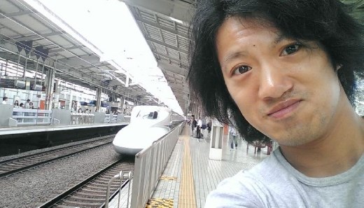 Me posing in front of the arriving bullet train