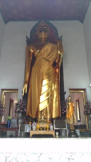 Giant standing Buddha opposite Phra Buddha Deva Patimakorn