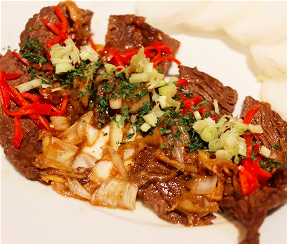 Beef: Closeup of the beef with green onion, scallion, and pickled ginger.