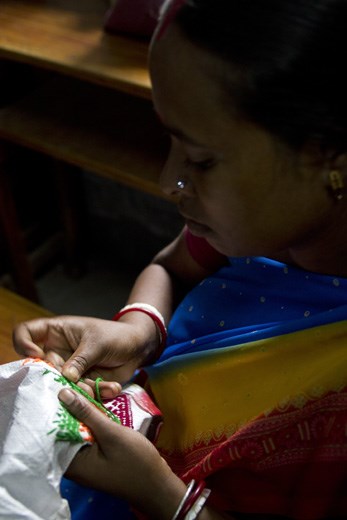 Shabitri, 36, will spend a few hours stitching an elaborate pattern on to cloth that will become a bag. One bag sells for Rs.500 ($8) and the steady flow of income helps Shabitri provide for her children who go to the Dakshini Prayash School. 