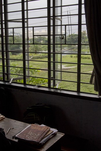 
At lunchtime, the students head off and their empty classrooms offer views of Madurdaha, a settlement on the eastern fringes of Calcutta. The concrete buildings of the city (seen in the distance) portray the rapid urbanisation that drove the residents of the village to the edge of poverty. 
