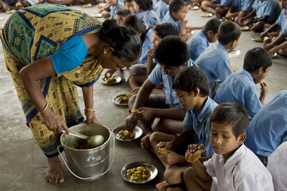Didi, the resident chef, gives the students poori-aloo (potatoes and bread) that she has lovingly cooked herself. The free lunch provided was one of the main reasons the students here first started coming to school 20 years ago. 
